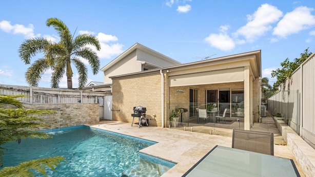 A backyard with a swimming pool, a covered patio, and a barbecue area. - "Poolside Escape in Scarborough" (Scarborough)