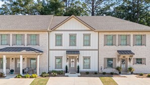 A two-story house with a front porch, a garage, and a well-maintained lawn. - Tiger’s Tail Trail 1245~Aubie's Reserve (Auburn)