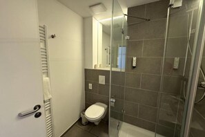 Shower, hair dryer, towels, toilet paper