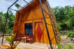 A wooden cabin with a porch, a door, and a window. - Asia Rainforest Resort (Semporna)