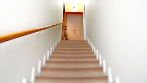 A staircase leading to a door with a light above it.