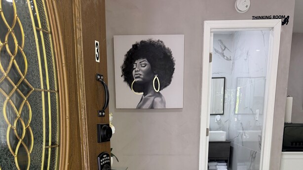 A modern bathroom with a marble floor, a framed artwork on the wall, and a 'Thinking Room' sign. - Studio in vibrant Miami near the ports of Miami. (Miami)