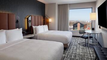 Hypo-allergenic bedding, desk, laptop workspace, blackout drapes