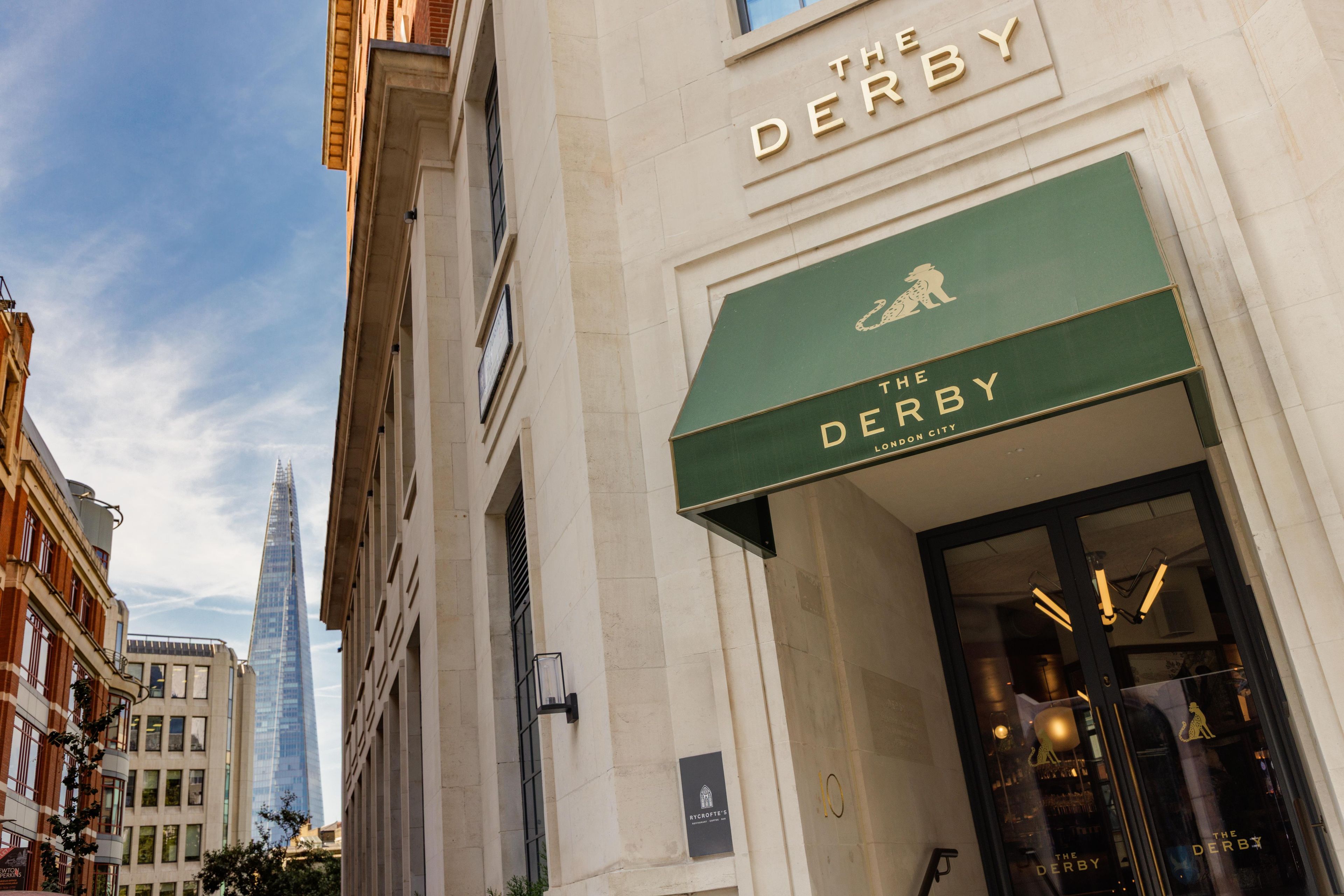 A building with a sign reading 'The Derby London City' and a swan logo.