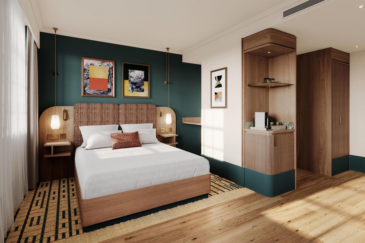 A modern bedroom with a wooden bed, bedside tables, a built-in wardrobe, and artwork on the walls.