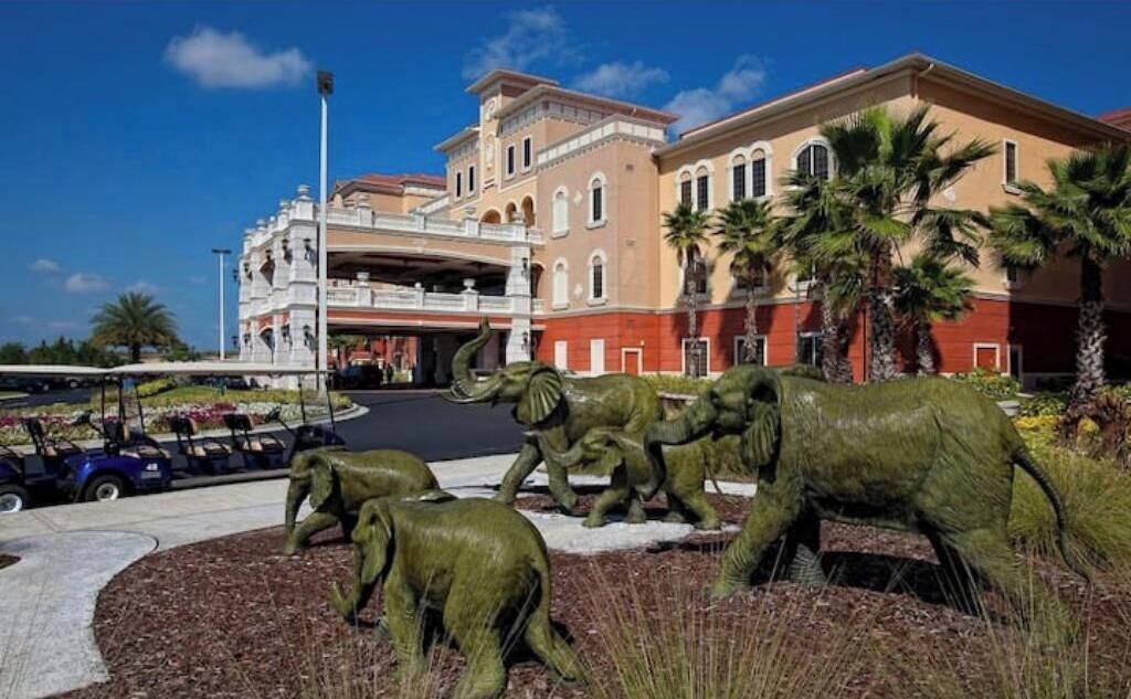 A building with a central atrium and a parking area with golf carts.