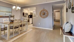 A modern kitchen with white cabinets, a microwave, and a refrigerator. - Spacious 3BR Hilton Head Getaway + Pool Access (Hilton Head Island)