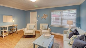 A living room with striped armchairs, a coffee table, a sofa, and a window with blinds. - Beach Getaway 2BR w/ Pool + Modern Comforts (Hilton Head Island)