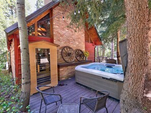 A wooden cabin with a hot tub, outdoor seating, and a rustic interior. - Quiet creekside retreat • Infrared sauna • Hot tub • Tucked in the pines • Close to Sundance (Sundance)