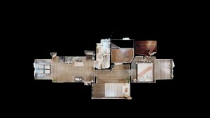 A top-down view of a hotel room layout with a kitchen, dining area, and a separate bathroom.