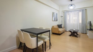 Una sala de estar moderna con una mesa de comedor, sillas, un sofá y una mesa de centro.