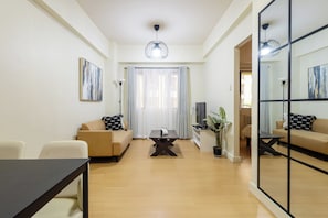 A modern living room with a sofa, a coffee table, and a dining table.