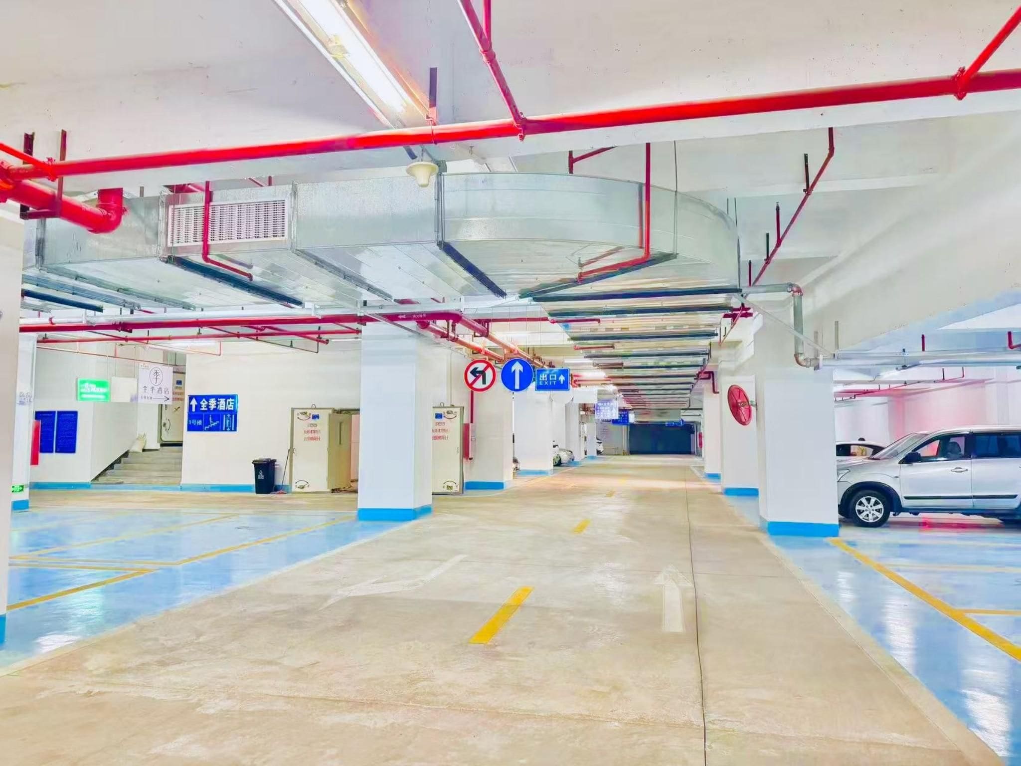 A multi-level parking garage with clear directional signage, including a sign for a hotel.