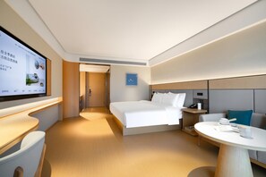 A modern hotel room with a bed, bedside table, and a TV screen. - Ji Hotel Guangzhou North Railway Station (Guangzhou)