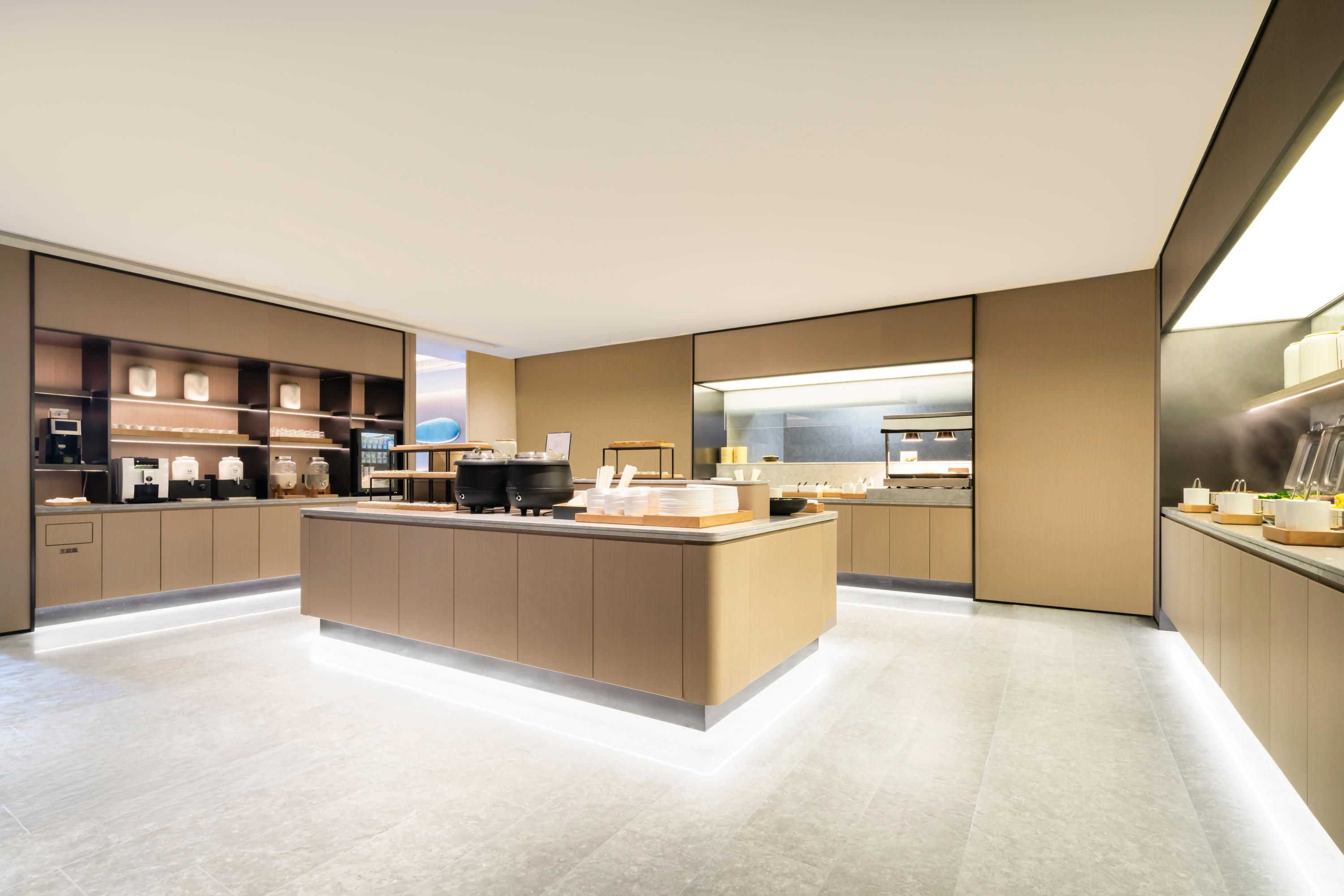 A modern kitchen with a central island, built-in appliances, and a sleek design.