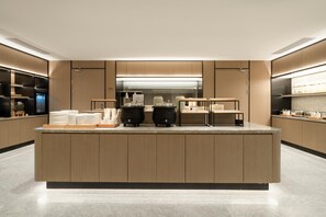 A modern kitchen with a central island, built-in appliances, and a sleek design.