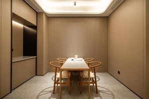 A conference room with a rectangular table, six chairs, a whiteboard, and a ceiling-mounted projector. - Ji Hotel Guangzhou Sun Yat-sen University Metro (Guangzhou)