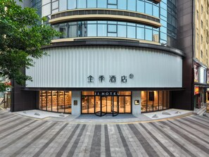 A hotel with a modern facade, large glass windows, and a prominent entrance with a revolving door. - Ji Hotel Guangzhou Sun Yat-sen University Metro (Guangzhou)