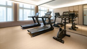 A modern gym with treadmills, elliptical machines, and a mirrored wall. - Ji Hotel Guangzhou Baiyun Tinggang Metro Station (Guangzhou)