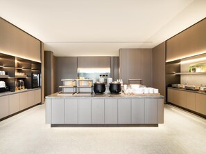 A modern kitchen with a central island, built-in appliances, and ample counter space.