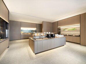 A modern kitchen with a central island, built-in appliances, and a clean, minimalist design.