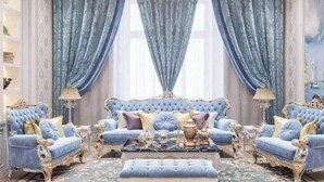 A luxurious room with a tufted sofa, matching armchairs, and a decorative coffee table. - Luxurious 5-bedroom villa with AC, fitness room in Beverly Hills (Beverly Hills)