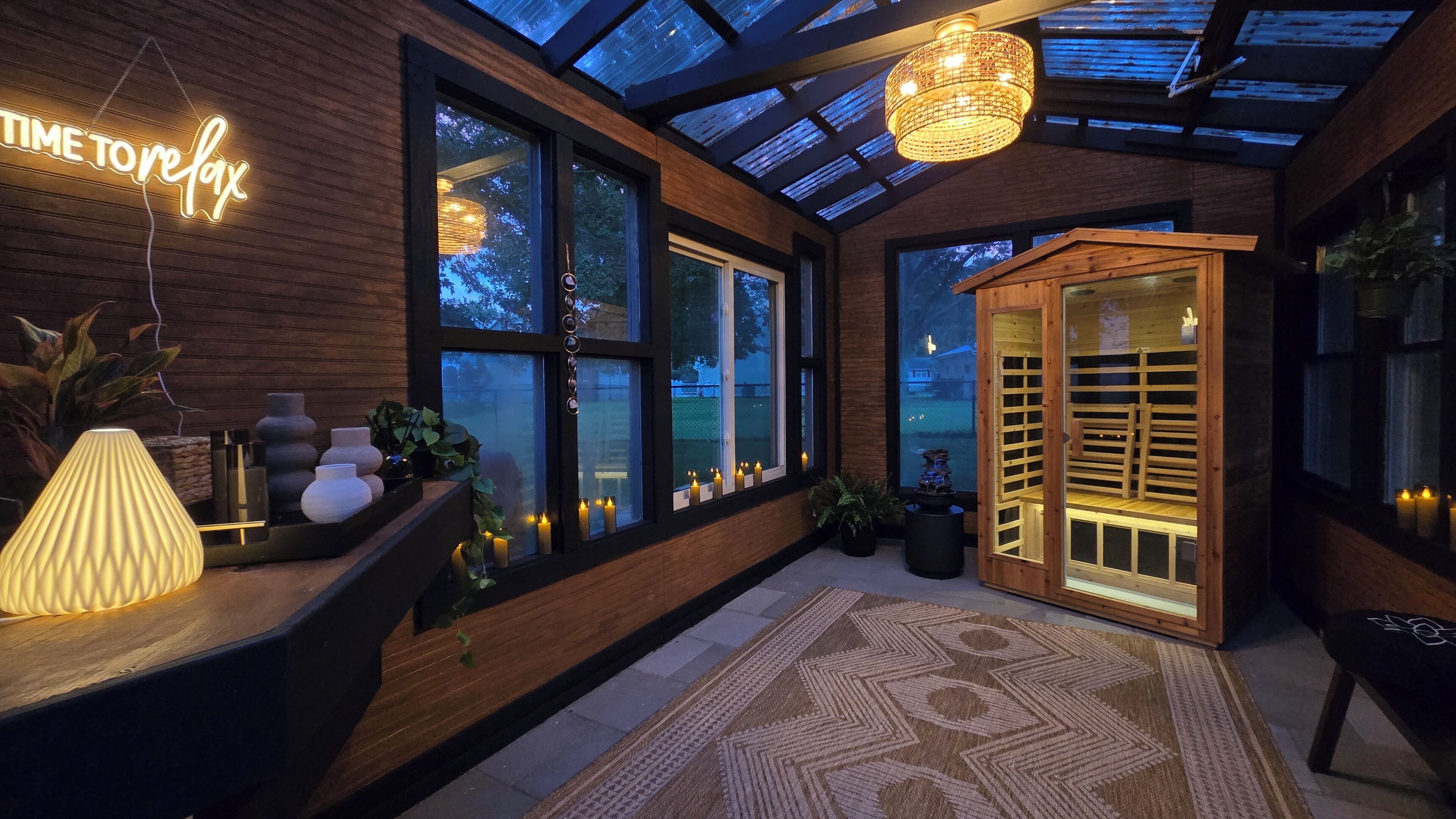 A modern interior with a skylight, wooden walls, and a reception desk with a neon sign.