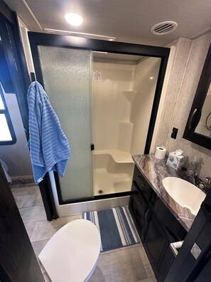 Shower, towels, soap, toilet paper