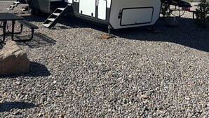 A recreational vehicle with a covered living area, a sliding door, and a ramp for access. - Luxury RV Camper Southern UTAH! (Toquerville)