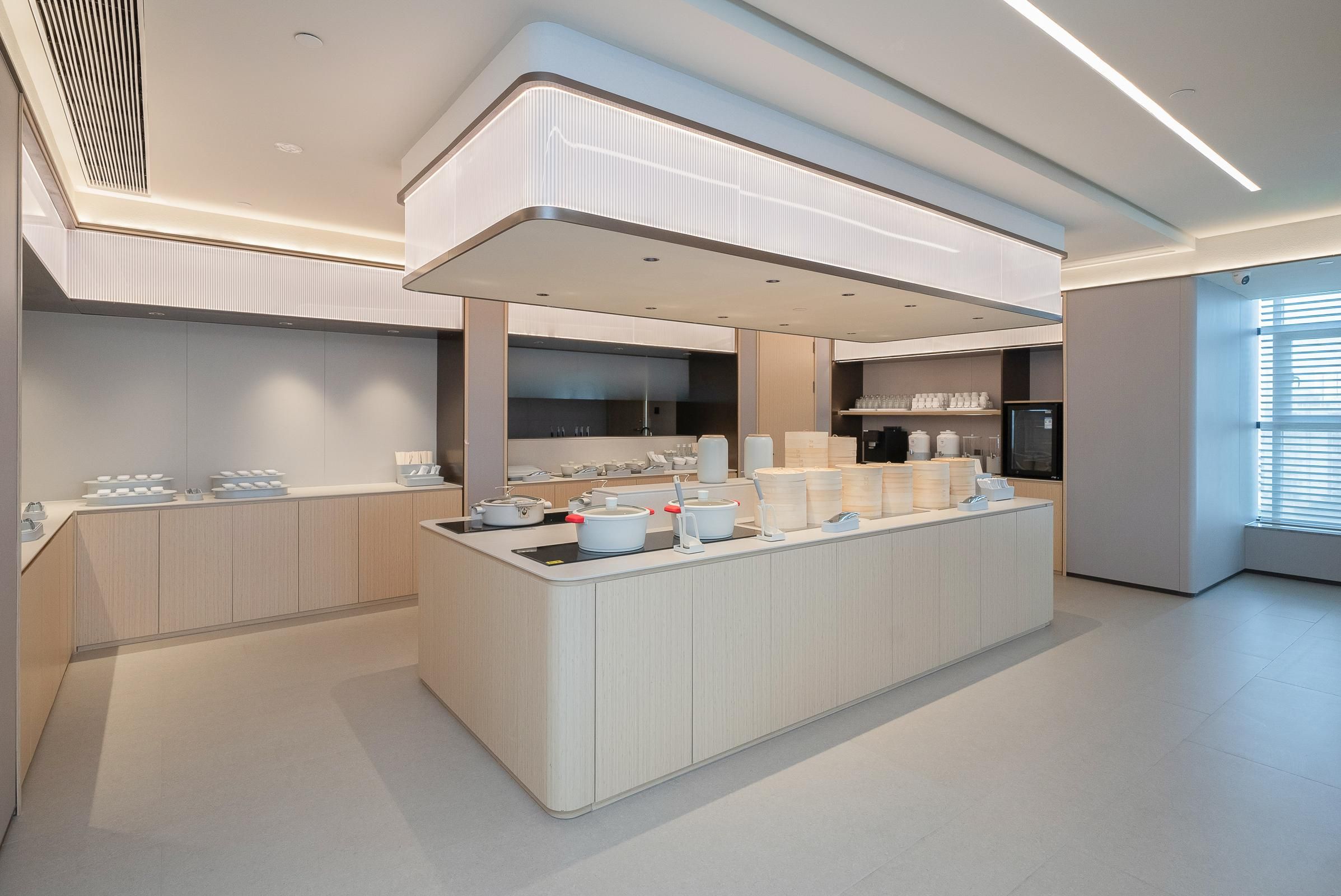 Una cocina moderna con una isla central, electrodomésticos integrados y mucho espacio de almacenamiento.