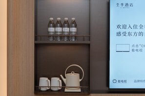 A hotel minibar with bottled water and tea set. - Ji Hotel Guangzhou Huangpu East Metro Station (Guangzhou)
