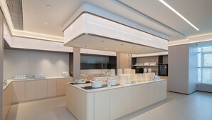 A modern kitchen with a central island, built-in appliances, and ample storage space.