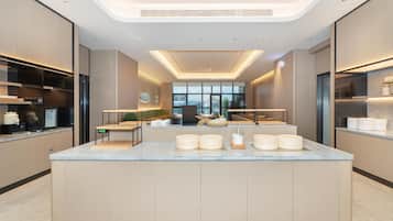 A modern kitchen with a central island, built-in appliances, and a view of the city.