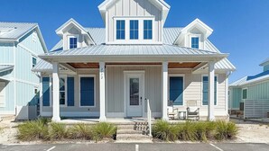 A coastal house with a gabled roof, a front porch with steps, and a number '272' on the door. - Salt and Sand at Summer Salt | Zero Entry Pool | Beach Access | Lake Fishing | My Beach Getaways (Orange Beach)
