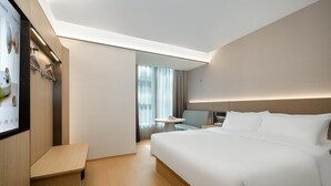 A modern hotel room with a large bed, a desk, and a television. - Ji Hotel Guangzhou Huangpu Science City Luogang (Guangzhou)