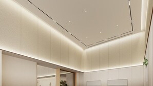 A modern hotel lobby with a long reception desk, seating area, and a large mirror. - Ji Hotel Guangzhou Huangpu Science City Luogang (Guangzhou)