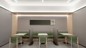 A modern, minimalist waiting area with green seating and white tables, featuring a neutral color palette and recessed lighting. - Ji Hotel Guangzhou Huangpu Science City Luogang (Guangzhou)