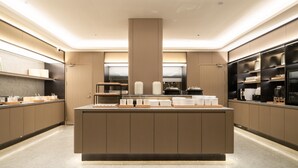 A modern kitchen with a central island, built-in appliances, and ample storage space. - Ji Hotel Guangzhou Huadu Square Metro Station (Guangzhou)