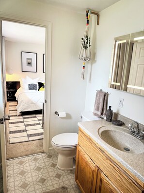 A bathroom with a wooden vanity, a large mirror, and a toilet. - 3-bedroom House 10Min to Lakes, Parks, and Downtown Bellevue (Bellevue)