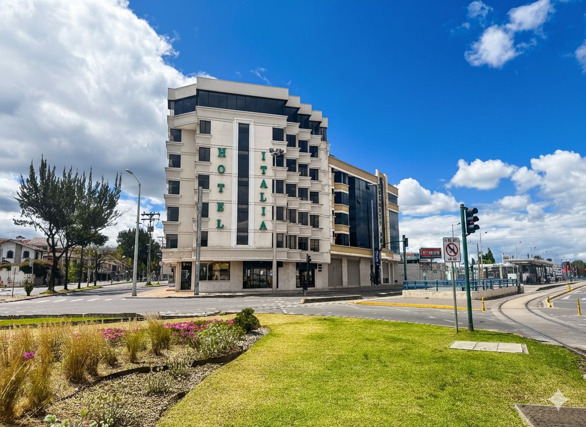 A modern hotel with a multi-story structure, a prominent entrance, and a well-maintained lawn area.