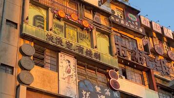 A multi-story building with various signs and advertisements.