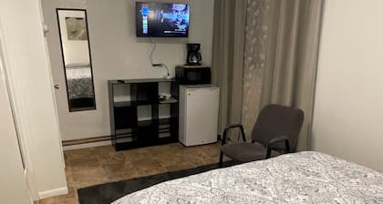 Studio with a Queen bed, shower cabin and toilet, shared access to free laundry