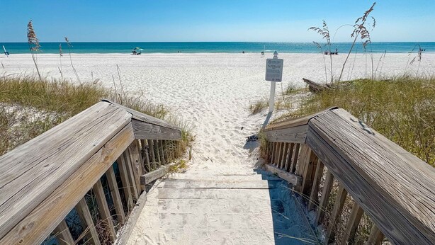 A wooden boardwalk leading to a sandy beach with a clear blue sky. - Huge Private Pool | Firepit | Beach One Block Away (gulf shores)