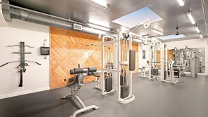 A gym with various exercise equipment, a wooden wall, and a skylight. - Penthouse with Ocean view from the upper balcony - B314 North Coast Village (Oceanside)