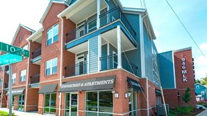 A two-story apartment building with a storefront labeled "Townhomes & Apartments."