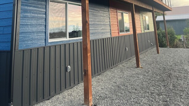 A modern two-story building with a wooden deck and large windows. - Heart of Homer - Redoubt (Homer)