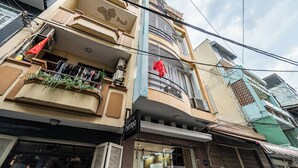 A multi-story building with a visible storefront labeled "Tattoo." - Saigon Central Group Stay  (Ho Chi Minh City)
