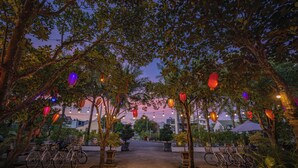 An outdoor area with trees, bicycles, and lanterns. - CocoPalm Hoi An River Beach By JM Villas (Hoi An)