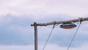 A wooden swing structure with a sign reading "Welcome to Gua Daibach". - CocoPalm Hoi An River Beach By JM Villas (Hoi An)