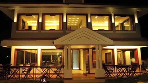 A two-story building with a balcony and a covered entrance. - SPACE4 RESORT (Ooty)